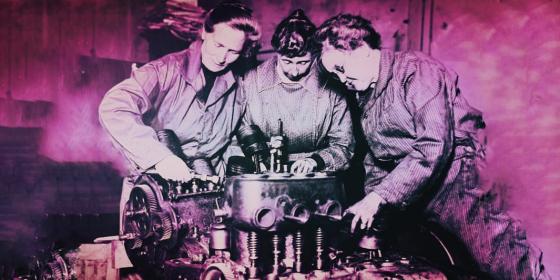 Three ladies working on an engine